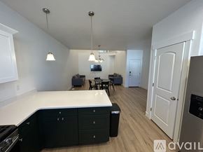 Lehi apartment for rent - A kitchen with black cabinets and a white countertop is shown.