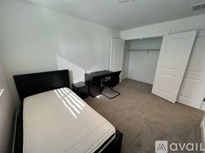 Lehi apartment for rent - A bedroom with a bed, dresser, and closet.