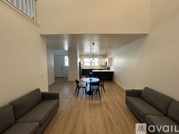 Lehi apartment for rent - A living room with a grey couch and a black table.