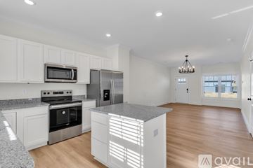 Jonesborough apartment for rent - A kitchen with white cabinets and a granite countertop.