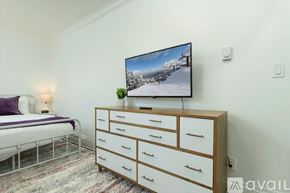 Oneonta apartment for rent - A bedroom with a bed, a dresser with a television on top, and a rug on the floor.