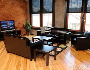 Williamsport apartment for rent - A living room with a leather couch and a television.
