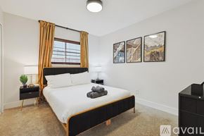 Plano house for rent - A bedroom with a large bed, a window with curtains, and a nightstand with a lamp.