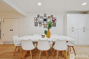 Plano house for rent - A dining room with a white table and chairs.