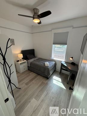 San Diego apartment for rent - A bedroom with a bed, nightstand, and a ceiling fan.