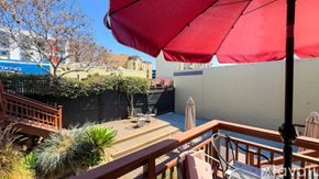 San Diego apartment for rent - A red umbrella is on a balcony overlooking a pool.