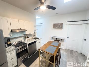 San Diego apartment for rent - A kitchen with a table and chairs in the middle of the room.