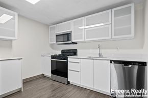 Boston apartment for rent - A kitchen with white cabinets and appliances.