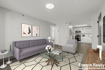 Boston apartment for rent - A living room with a grey couch, a glass coffee table, and a painting on the wall.
