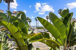 Imperial Beach condo for rent - A bedroom with a large bed and a wooden headboard.