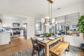 Huntington Beach house for rent - A modern dining room with a wooden table and chairs.