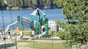 Truckee house for rent - A playground with a green slide and a blue sky in the background.