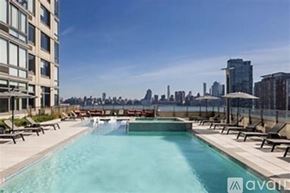 Jersey City apartment for rent - A swimming pool with a city skyline in the background.