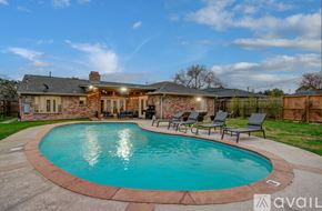 Houston house for rent - A house with a pool in the backyard.