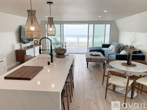 Huntington Beach apartment for rent - A modern kitchen with a large island and a view of the beach.