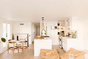 Huntington Beach apartment for rent - A modern kitchen with white cabinets and a dining table with chairs.