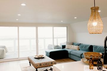 Huntington Beach apartment for rent - A living room with a blue couch and a wooden coffee table.