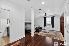 New Orleans house for rent - A bedroom with a large bed and a chandelier.