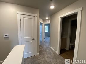 Caldwell apartment for rent - A room with a white door and a window with a view of a building outside.
