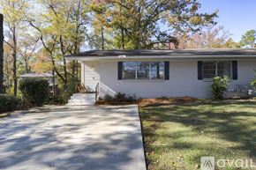 Vestavia Hills condo for rent - A house with a driveway and trees in the background.