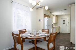 Vestavia Hills condo for rent - A dining room with a table set for two and a kitchen in the background.