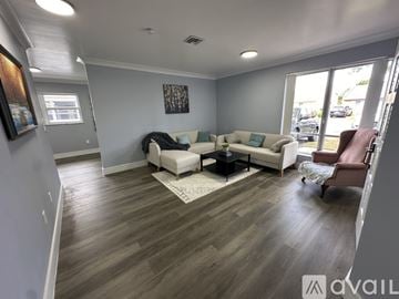 Fort Lauderdale house for rent - A living room with a white couch and a brown chair.