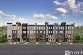 Herndon apartment for rent - A large, modern building with a row of windows on the ground floor and balconies on the upper floors.