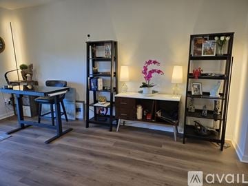 Herndon apartment for rent - A living room with a grey couch, a coffee table, and a painting on the wall.