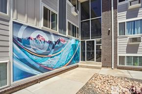Colorado Springs apartment for rent - A mural of a mountain range is painted on the side of a building.