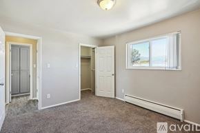 Colorado Springs apartment for rent - A room with a carpeted floor, a window, and a door.