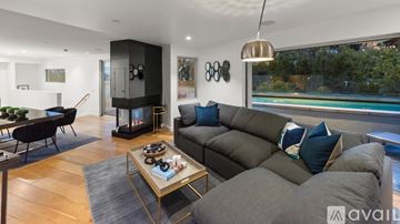 West Hollywood apartment for rent - A modern living room with a grey sofa and a coffee table.