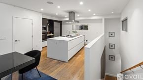 West Hollywood apartment for rent - A modern kitchen with a dining table and chairs.