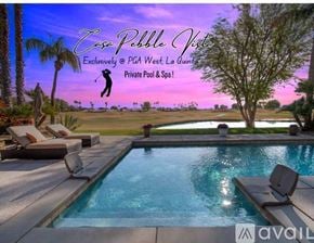 La Quinta house for rent - A poolside lounge area with a view of a golf course at dusk.