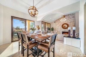 La Quinta house for rent - A dining room with a wooden table and chairs.