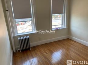 Boston apartment for rent - A room with wooden floors and two windows.