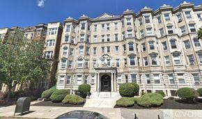 Boston apartment for rent - A large, multi-story building with a central entrance and steps leading up to it.