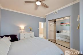 Huntington Beach house for rent - A bedroom with a large bed and a mirrored closet door.