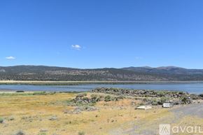 Susanville house for rent - A landscape with a lake, mountains and a clear sky.