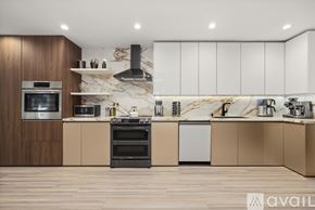 Los Angeles house for rent - A modern kitchen with wooden cabinets and a marble backsplash.