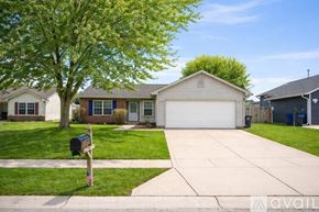 Kokomo house for rent - A bedroom with a bed, pillows, a nightstand, and a window.
