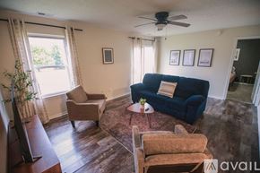Kokomo house for rent - A bedroom with a bed, nightstand, and pictures on the wall.