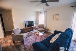 Kokomo house for rent - A bedroom with a bed, a ceiling fan, and a nightstand.