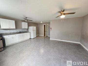 Houston apartment for rent - A kitchen with white cabinets and a fan on the ceiling.