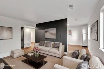 Highland Heights apartment for rent - A living room with a white couch, a coffee table, and a painting on the wall.