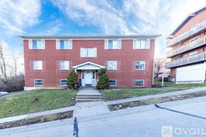 Highland Heights apartment for rent - A red brick building with a white door and windows.