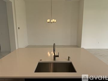 Palm Beach Gardens house for rent - A modern kitchen with a sink and a chandelier.