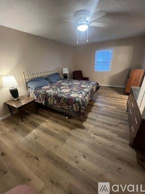 Carmel house for rent - A bedroom with a bed, nightstand, and chair.