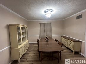 Carmel house for rent - A dining room with a wooden table and chairs.