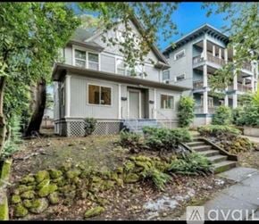 Portland apartment for rent - A house with a front yard and a staircase leading to a balcony.