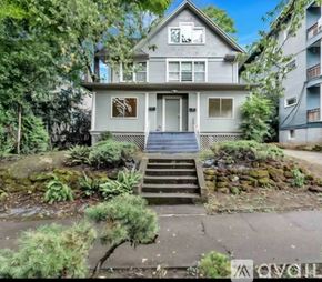 Portland apartment for rent - A house with a front yard and stairs leading to the front door.